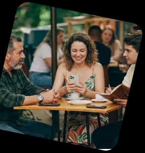Friends laughing over coffee at a café
